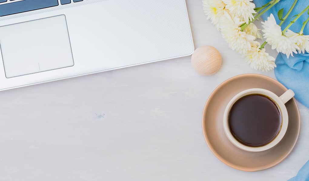 Coffee cup and laptop